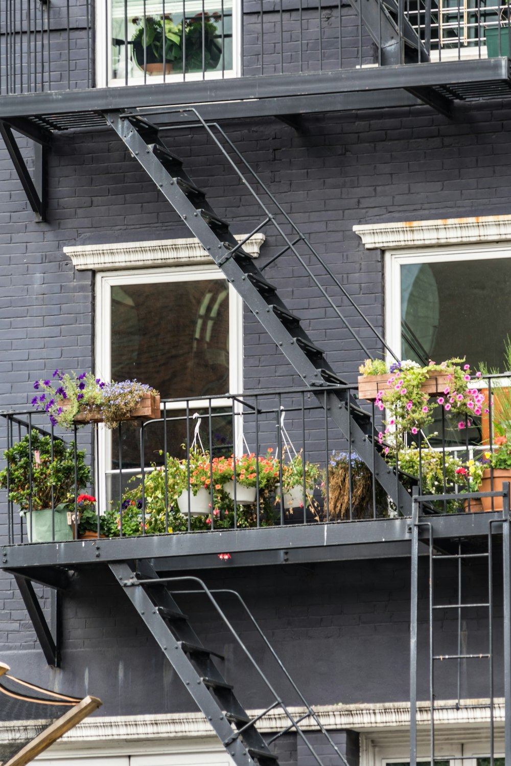 a building with a staircase and flowers