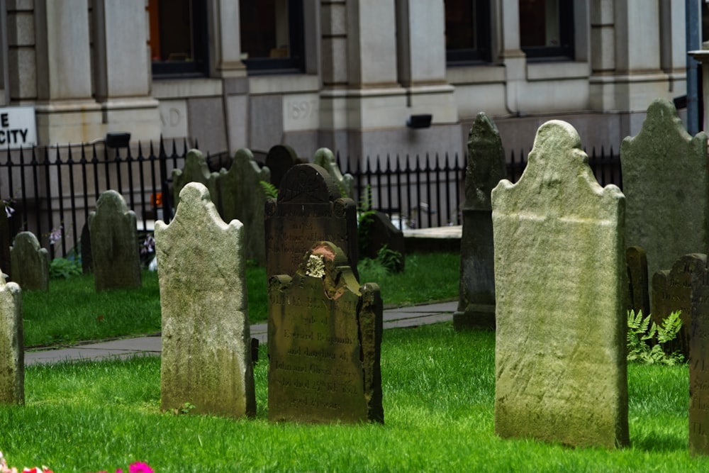 a group of stone headstones in a grassy area