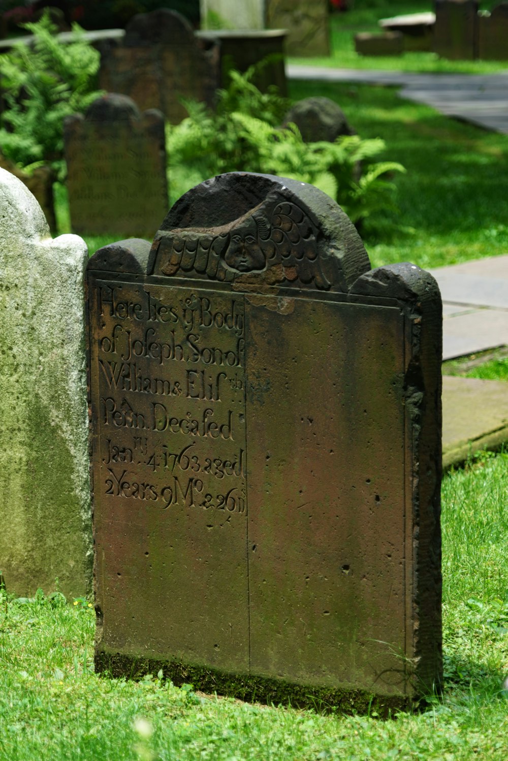 a tombstone in a graveyard