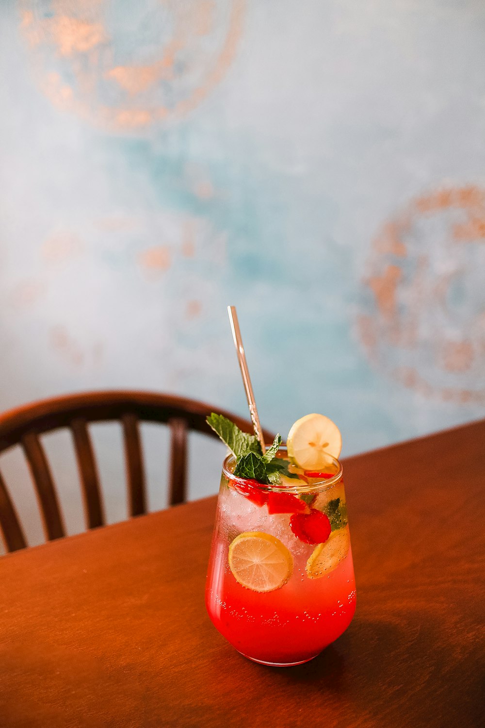 a red and white dessert with straws and a straw