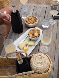 A rustic wooden table set with various Italian wines and glasses.