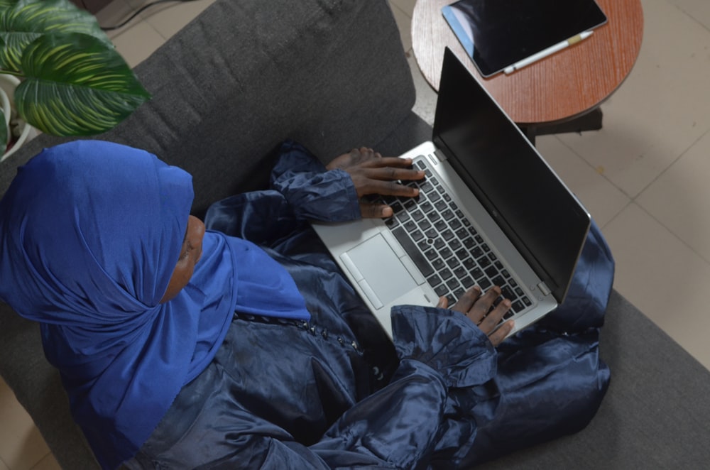 a person lying on the couch with a laptop