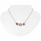 Elegant gold necklace with a custom diamond pendant displayed on a minimalist white bust.