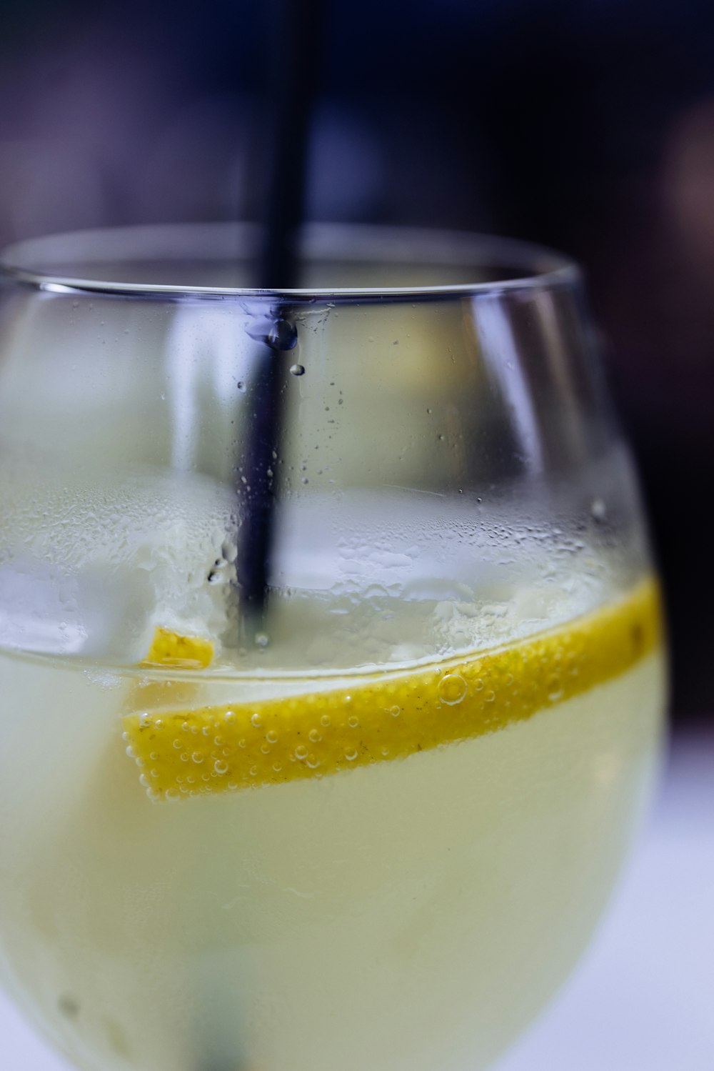 a glass of liquid with a spoon