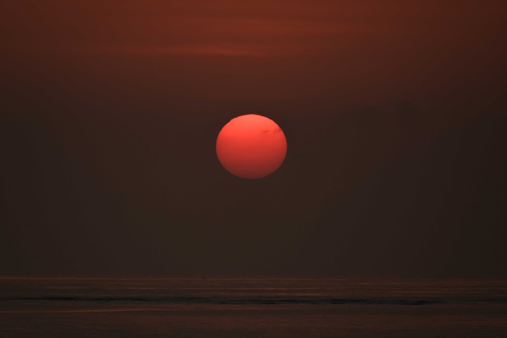 a red sun over a flat plain