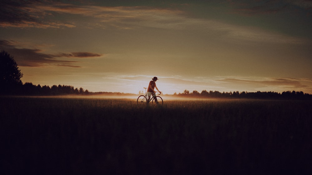 a person riding a bike in a field