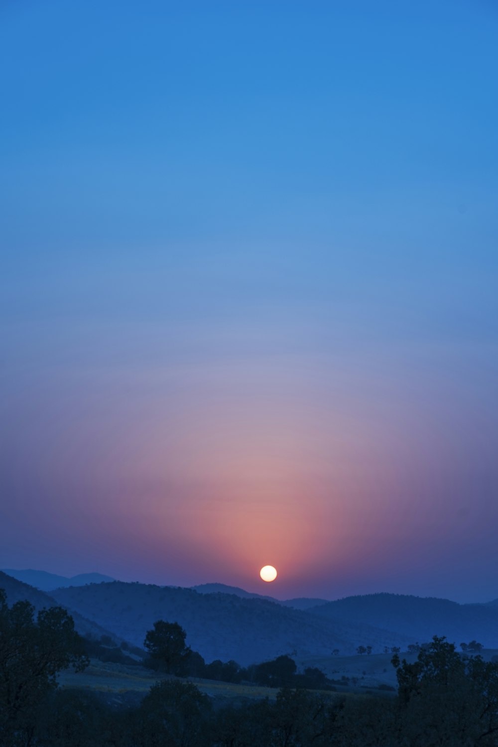 a sunset over a mountain range