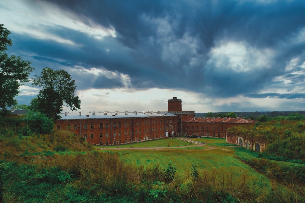 a large building with a green lawn