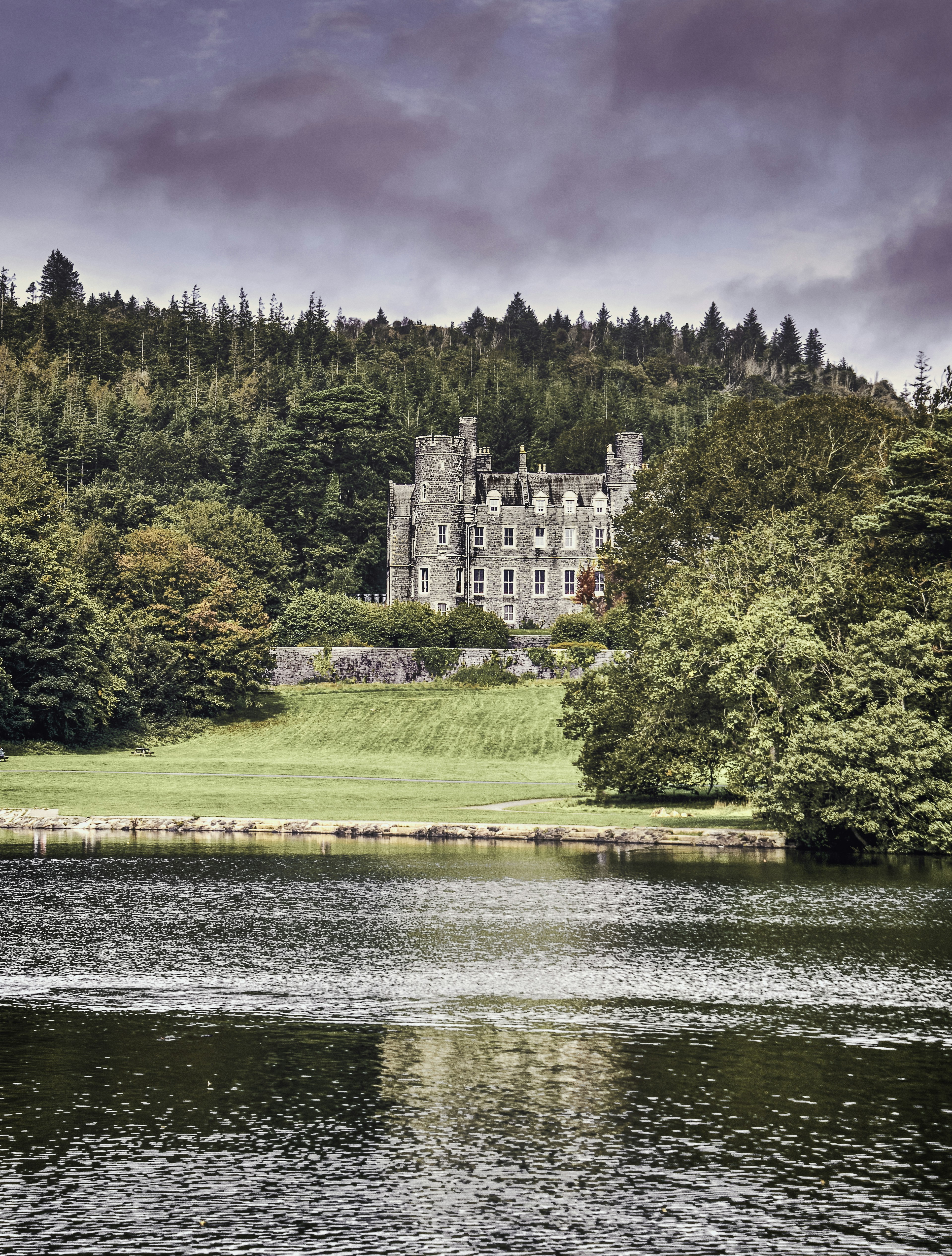 a castle on a hill by a river