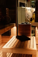 Cozy wooden sauna interior with warm lighting and natural wood textures.