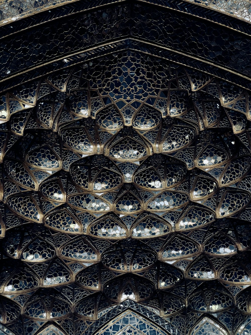 a ceiling with many intricate designs