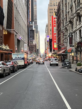 A busy street with various commercial buildings and signage.