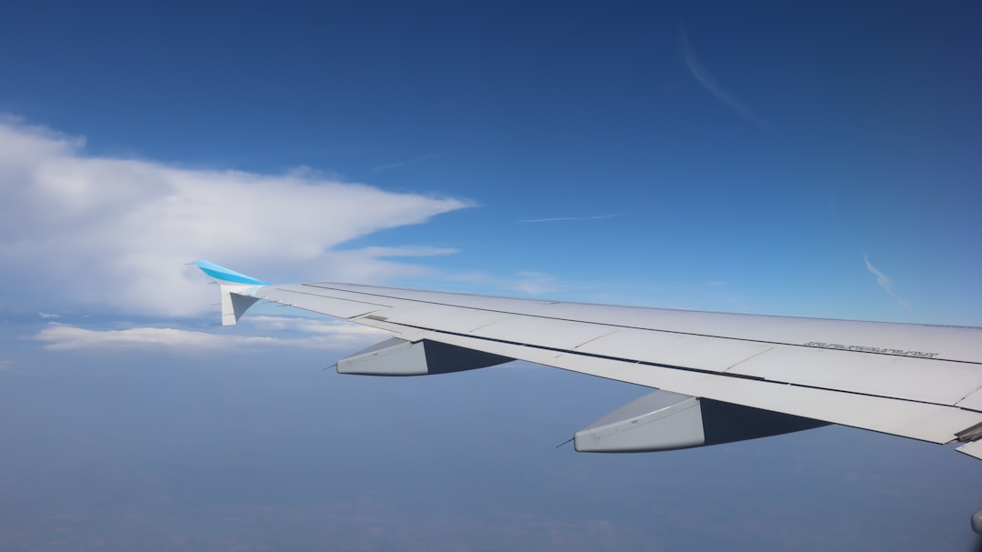 the wing of an airplane, A view from the window of an airplane flying above Europe.