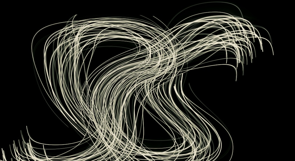 Abstract waves of light flowing over a dark background.