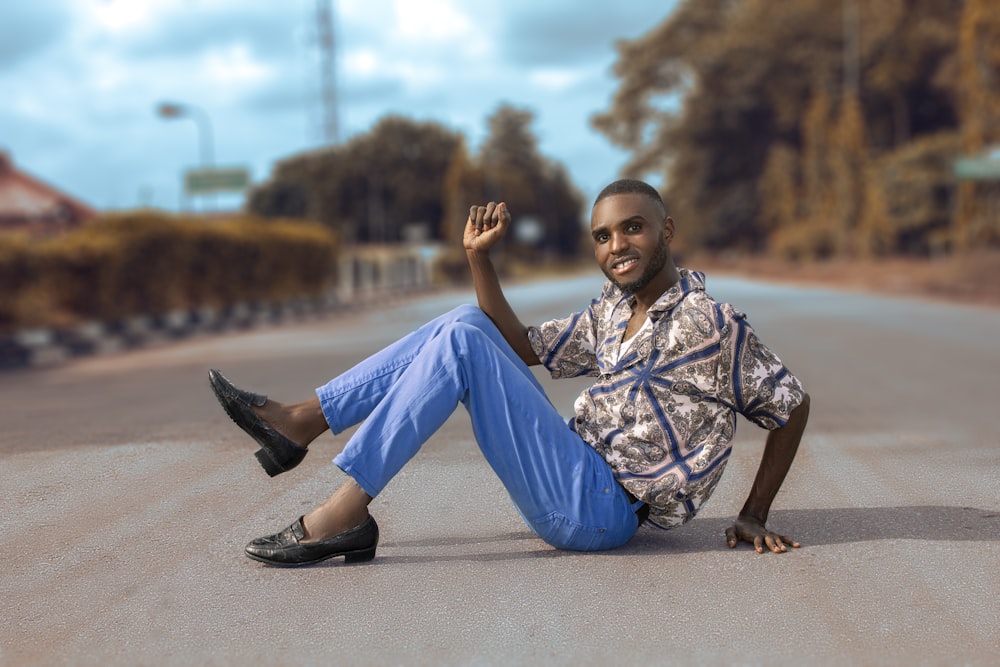a man sitting on the road