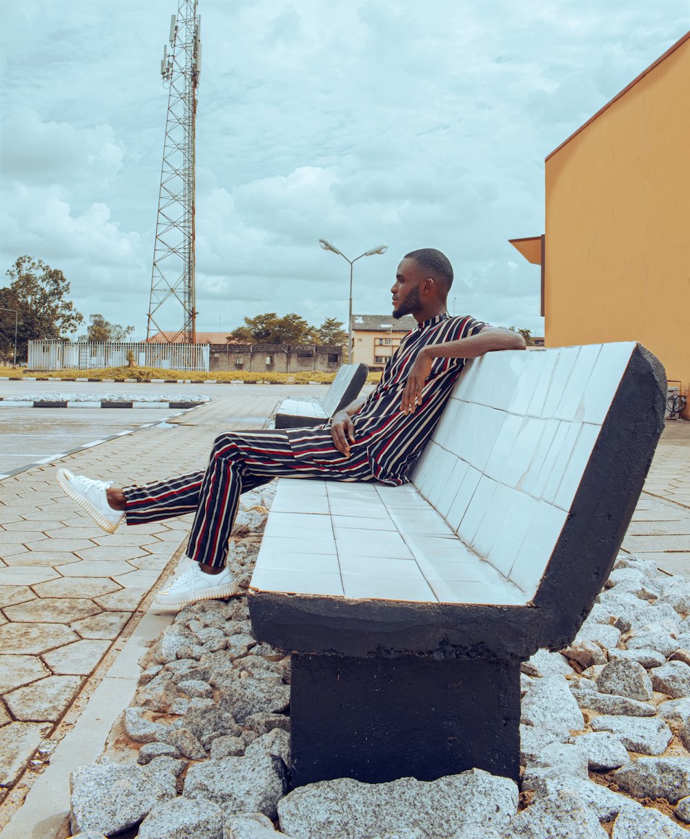 a person sitting on a bench with a laptop