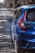 a blue car parked on a gravel road