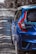 a blue car parked on a gravel road