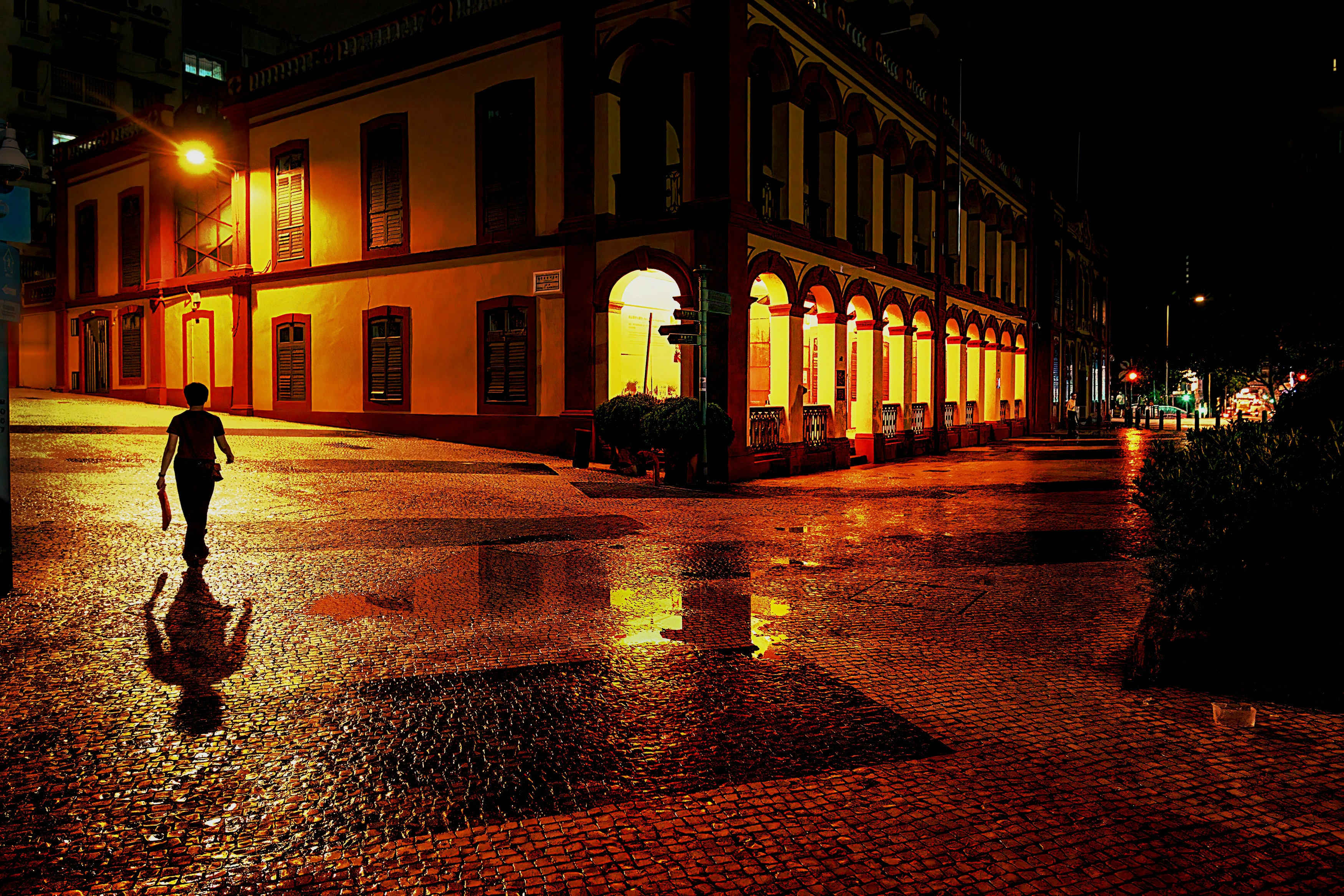 a person walking in a wet street