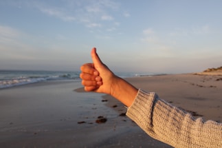 a hand on a beach