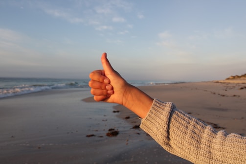 a hand on a beach