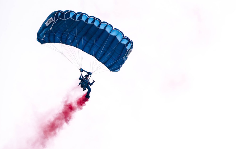 a person in the air with a parachute