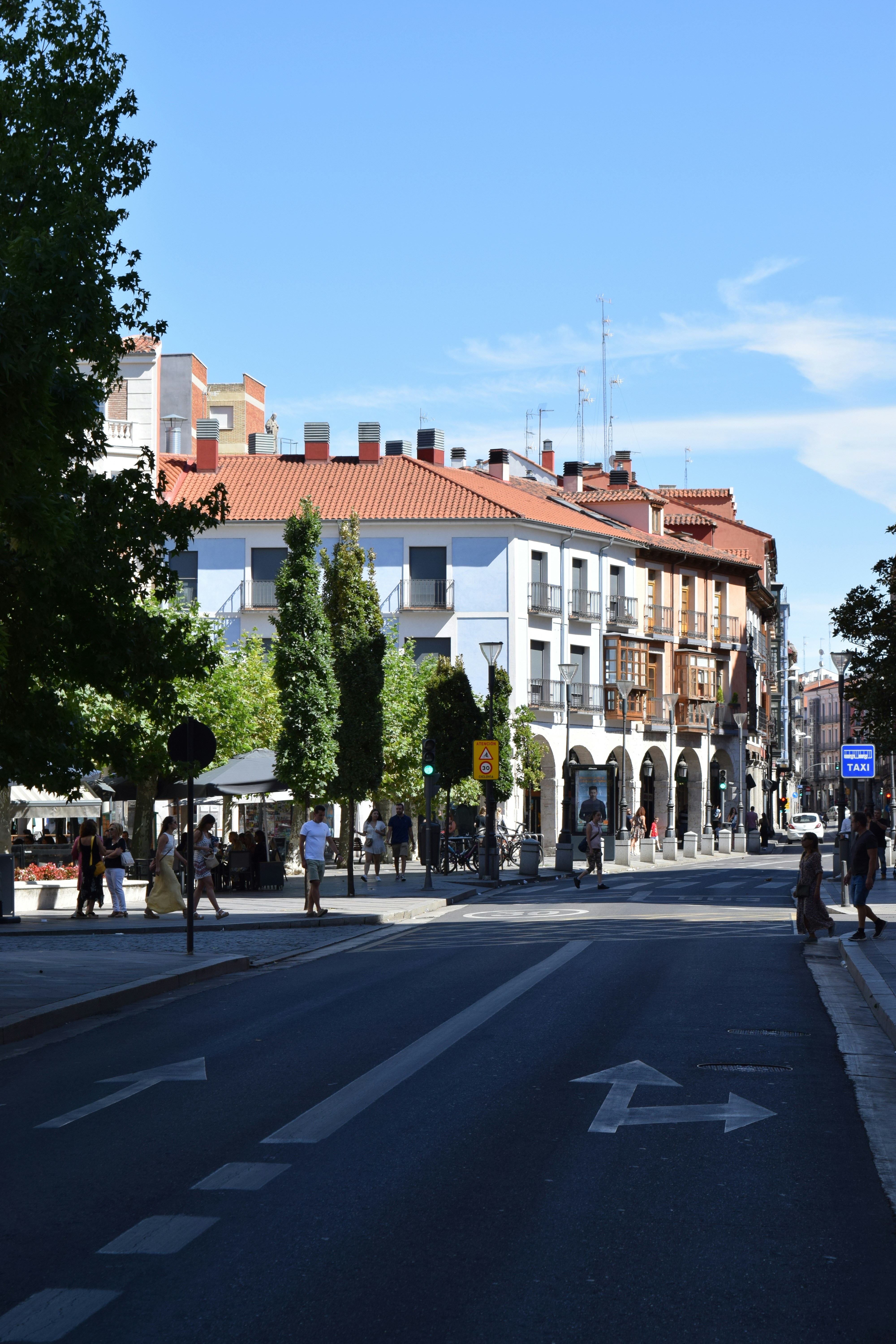 a street with people and buildings on the side