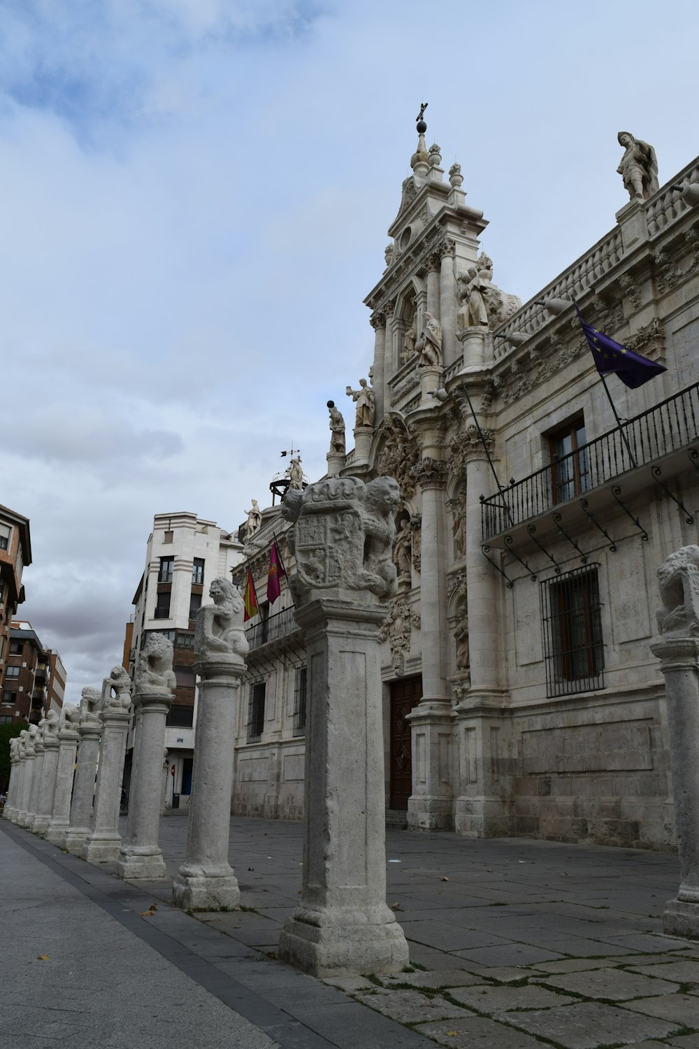 a stone building with statues on the top