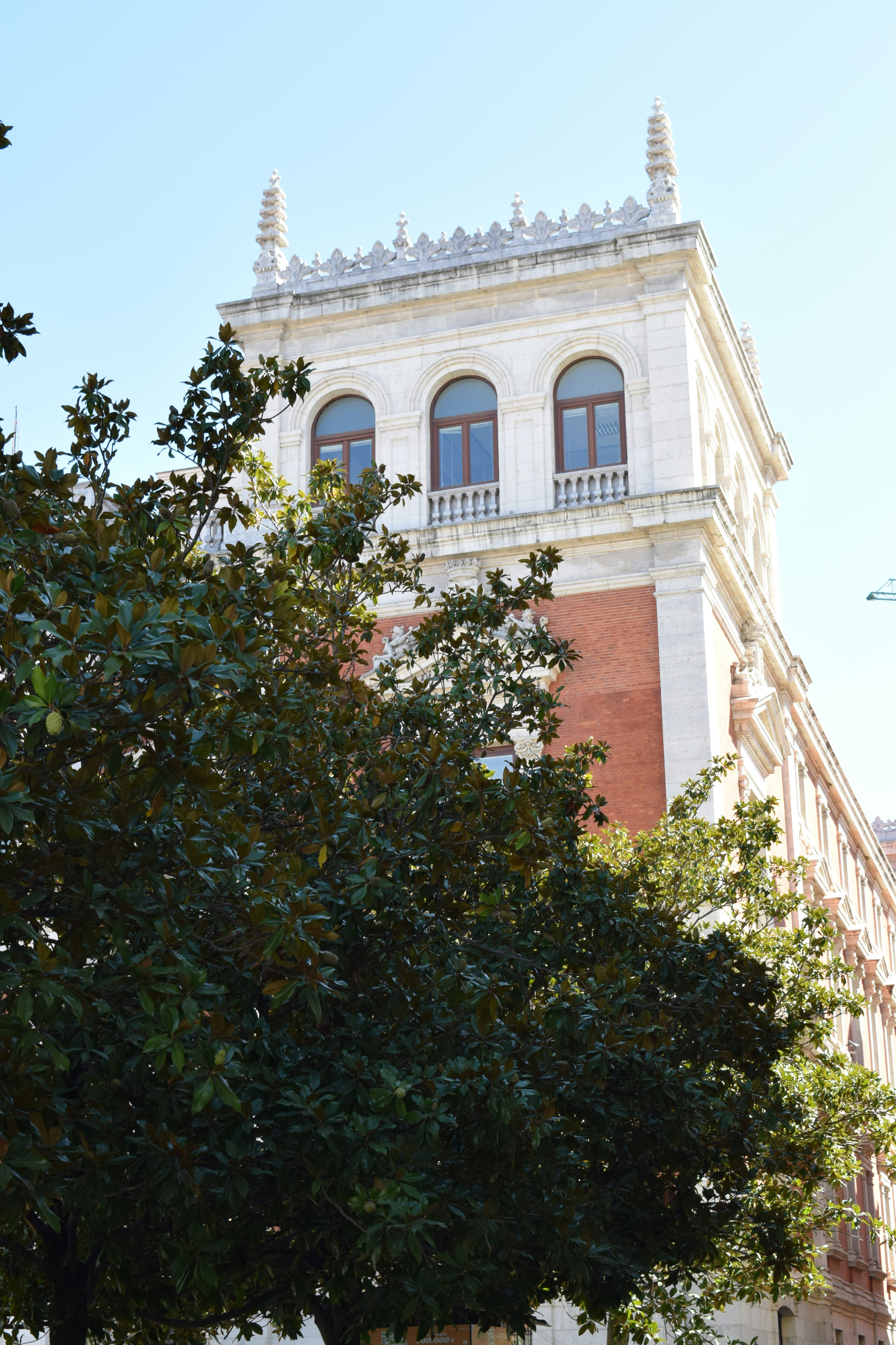 a tall building with a tree in front of it