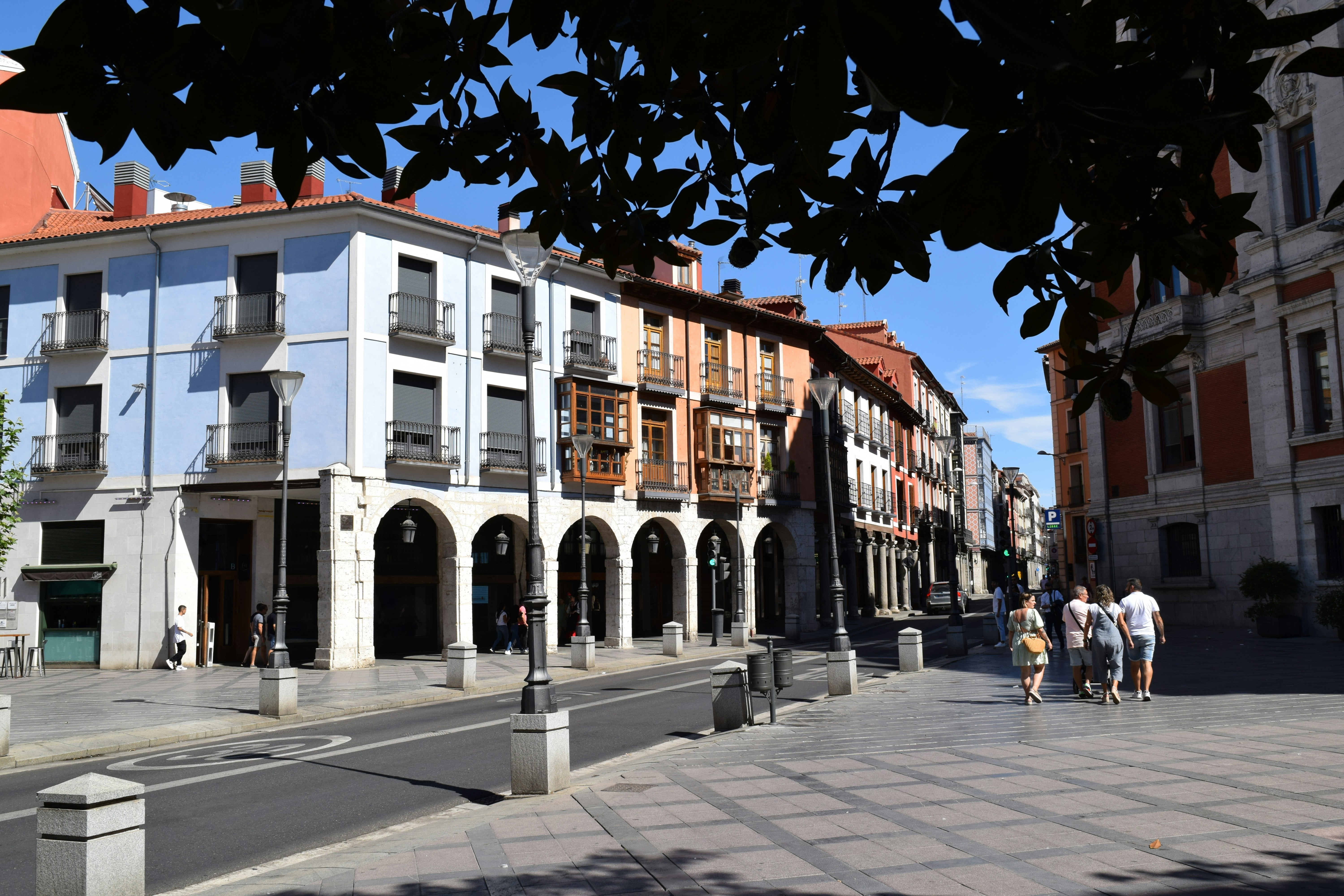 a group of people walking on a street next to a building