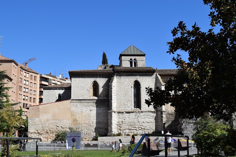 a stone building with a fence around it