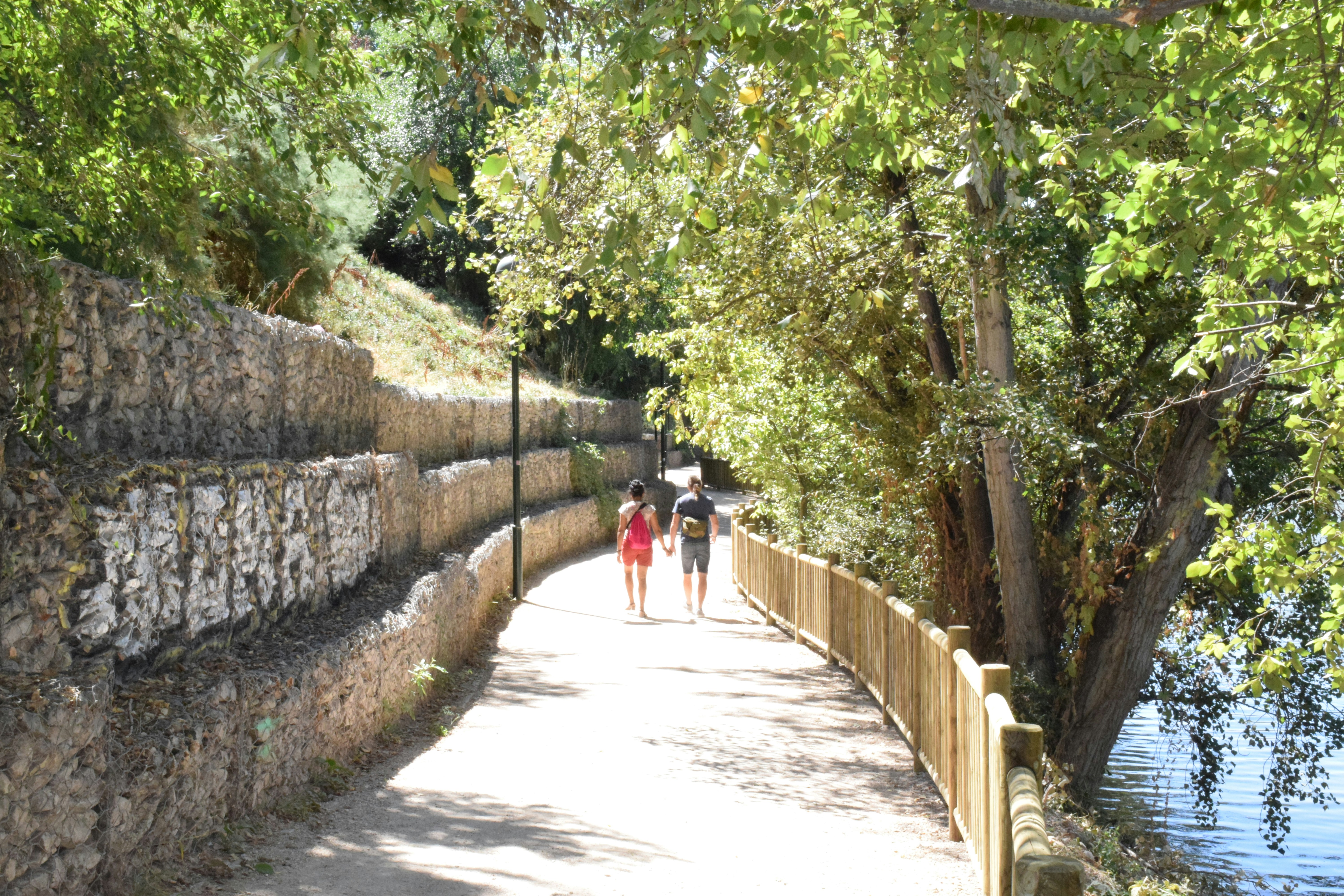 a couple people walking on a path