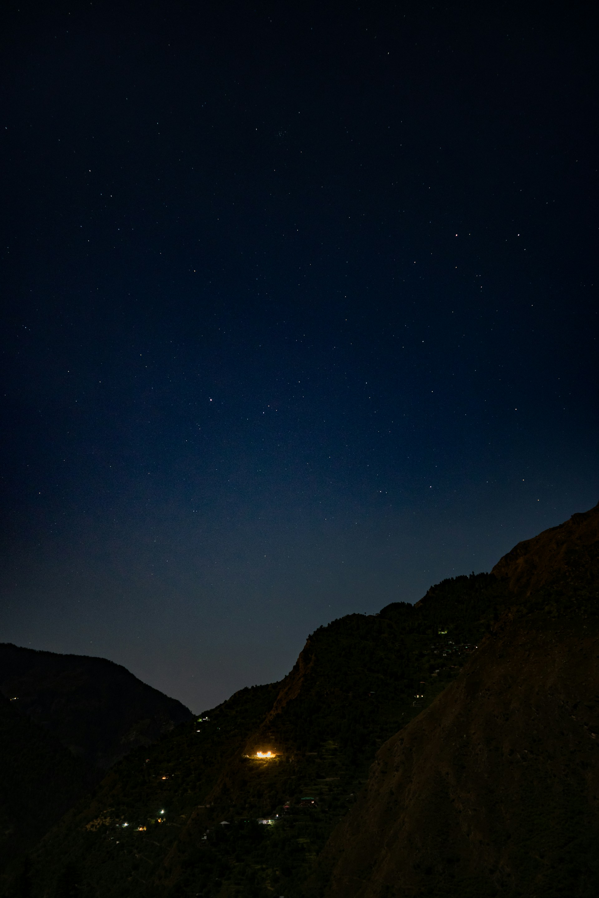 a mountain with a bright light in the sky