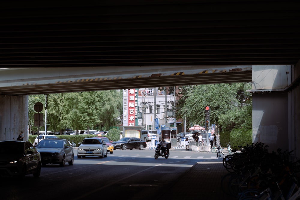 a street with cars and motorcycles