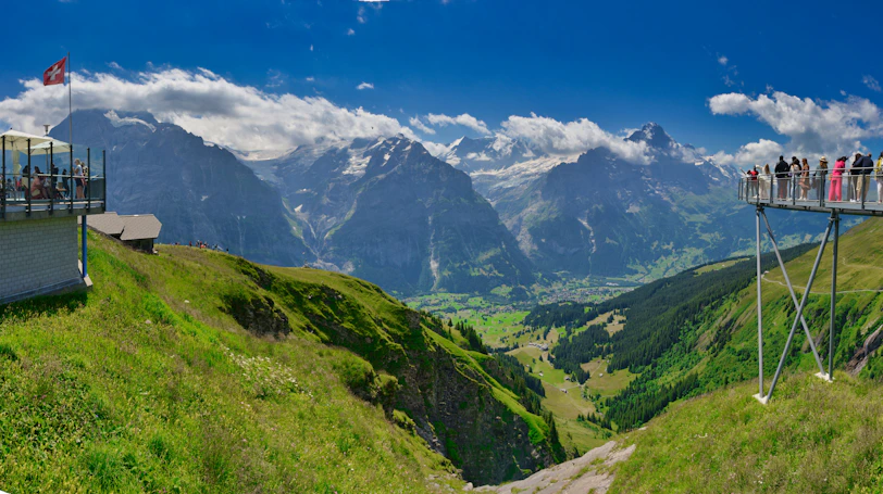 a group of people on a cable car above a mountain