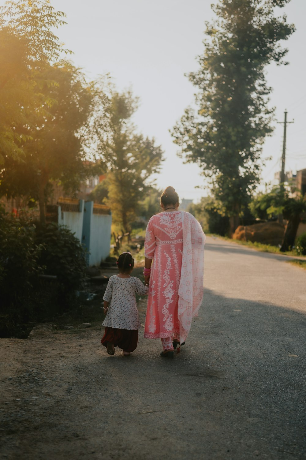 a person and a child walking down a street