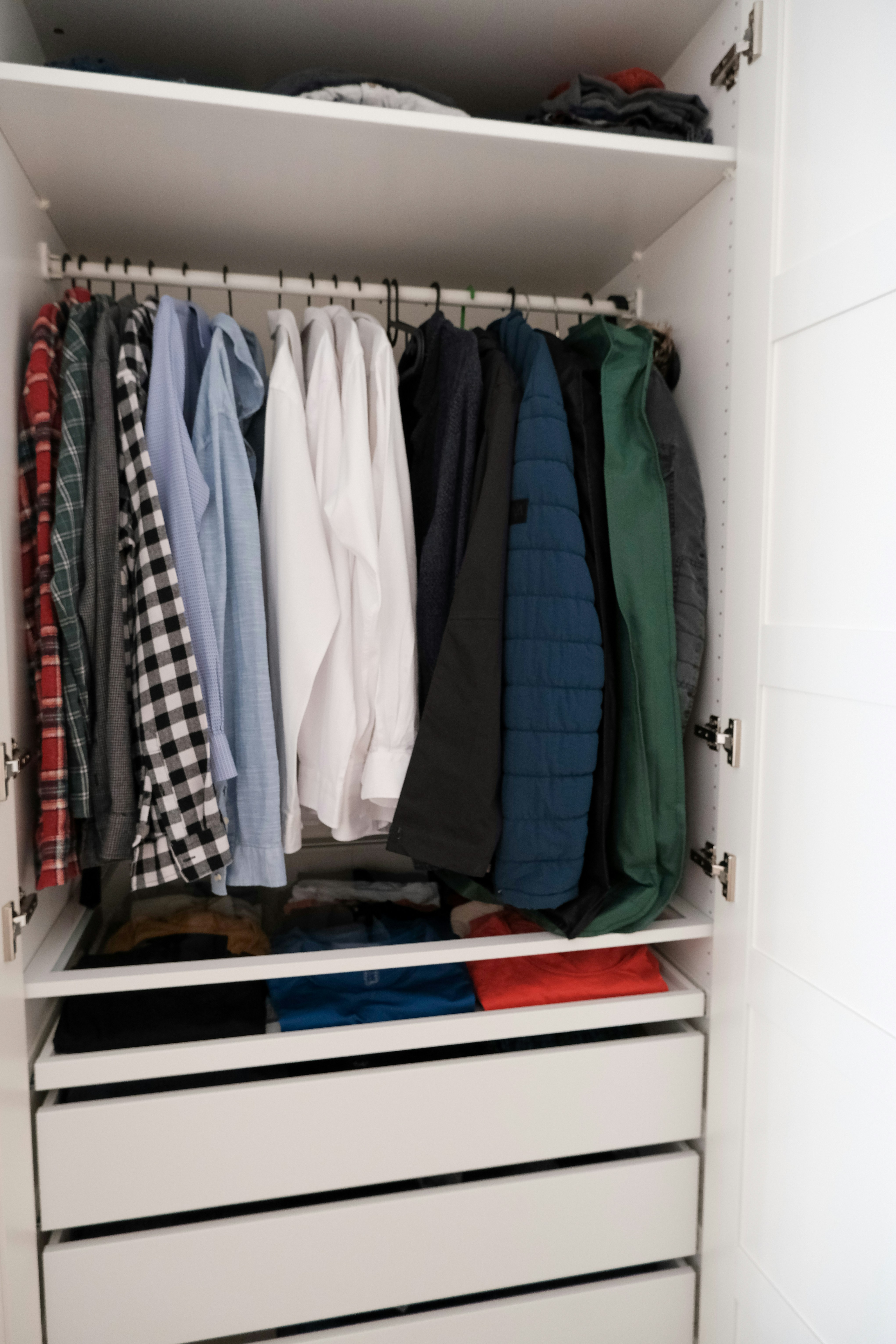 IKEA PAX Wardrobe, ikea white pax wardrobe, minimal shirts lined up with drawers, colorful t-shirts, ikea bedroom cabinets.