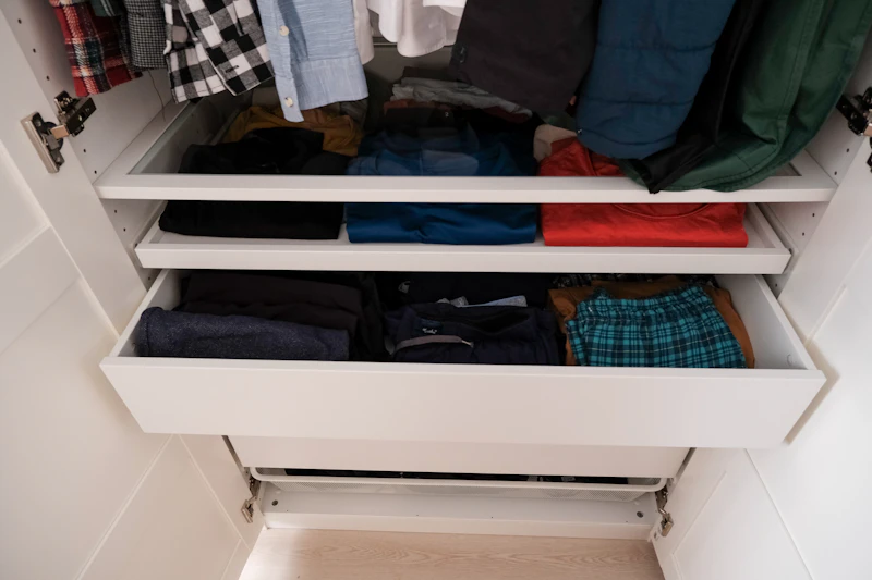 Built-in fitted wardrobe filled with hanging clothes