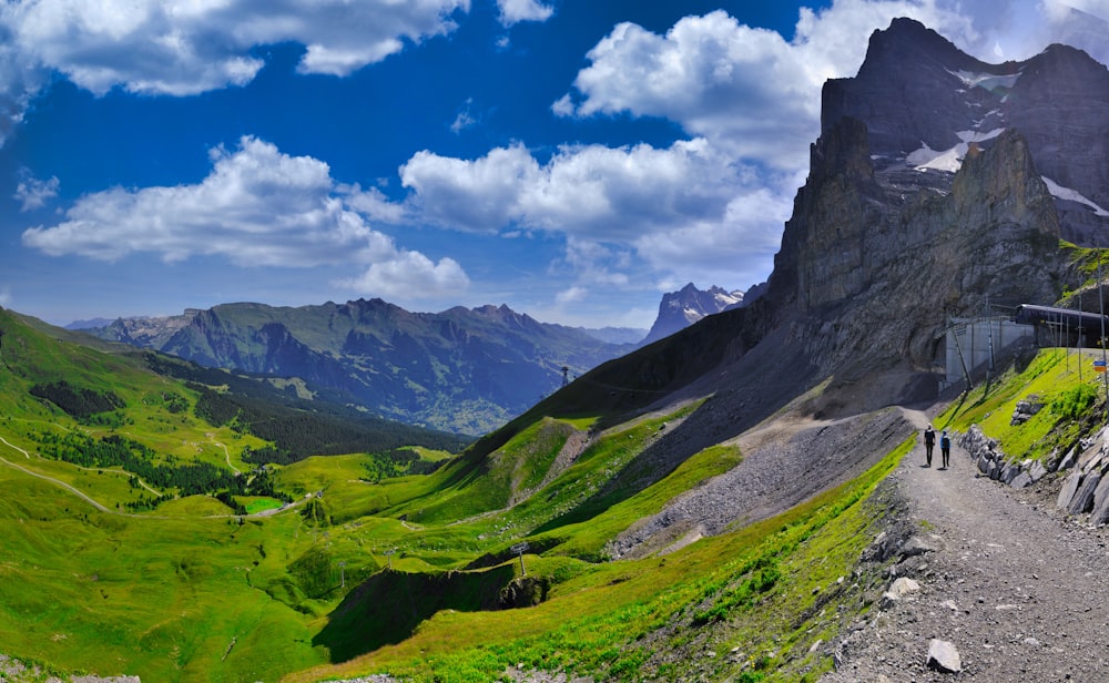 a mountain with a road and people walking on it