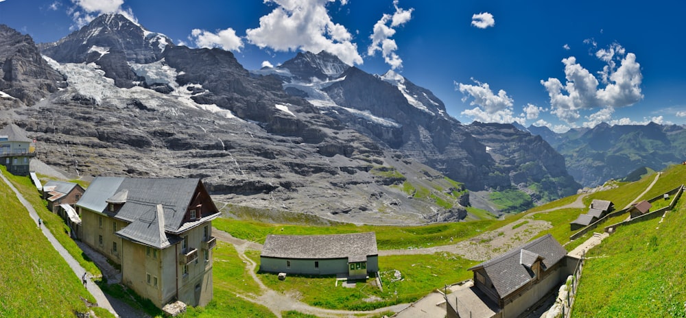 a group of buildings in a valley between mountains