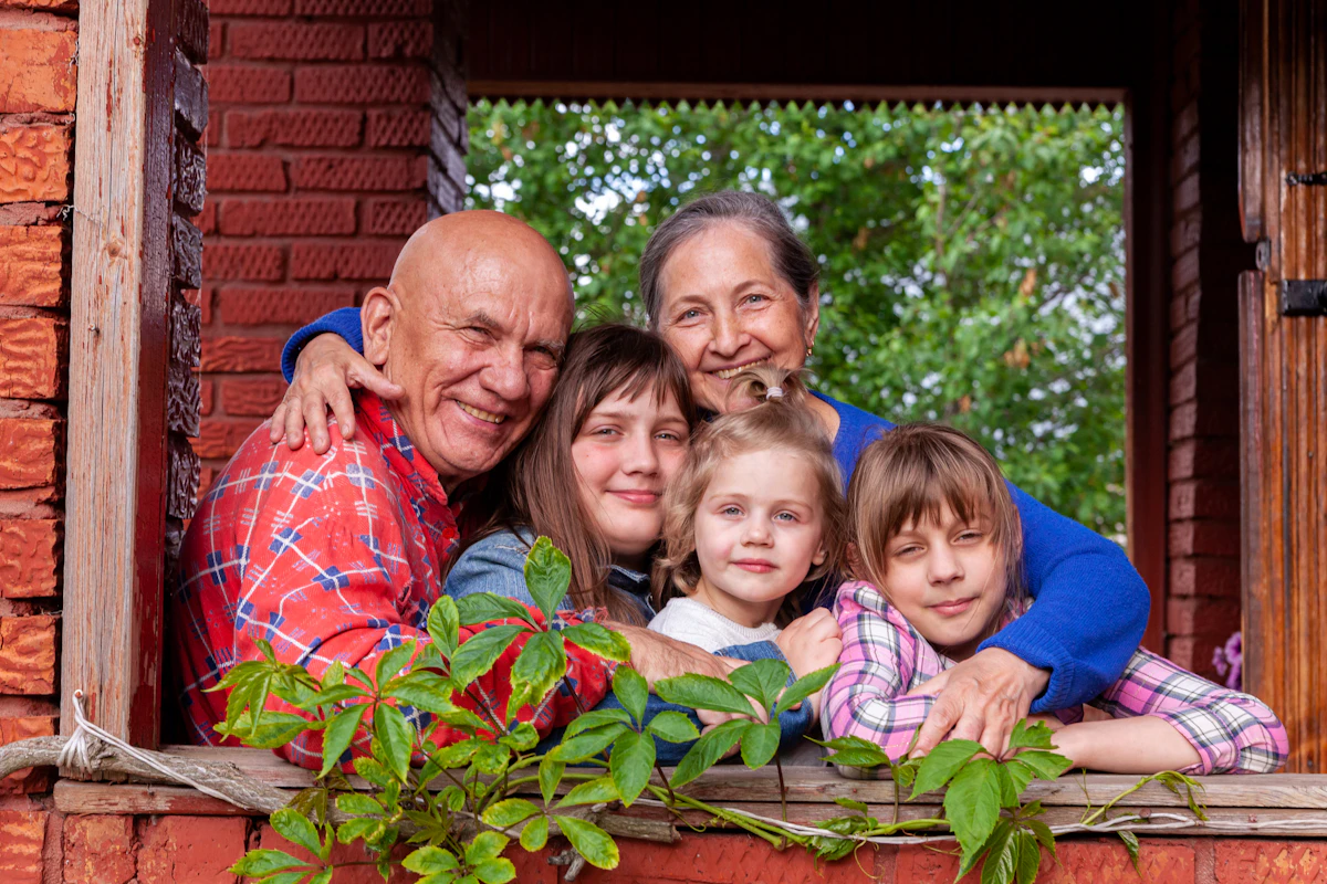 Grandparents and their grandchildren gathered at a window
