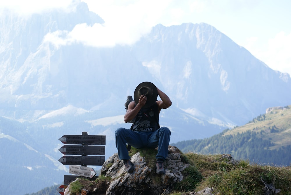 a man sitting on a rock with a camera on his head