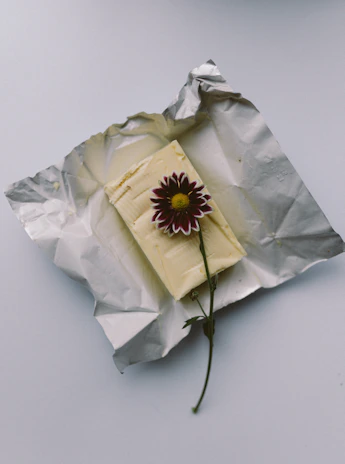 Freshly churned white butter resting on a wooden board with saffron-gold accents.