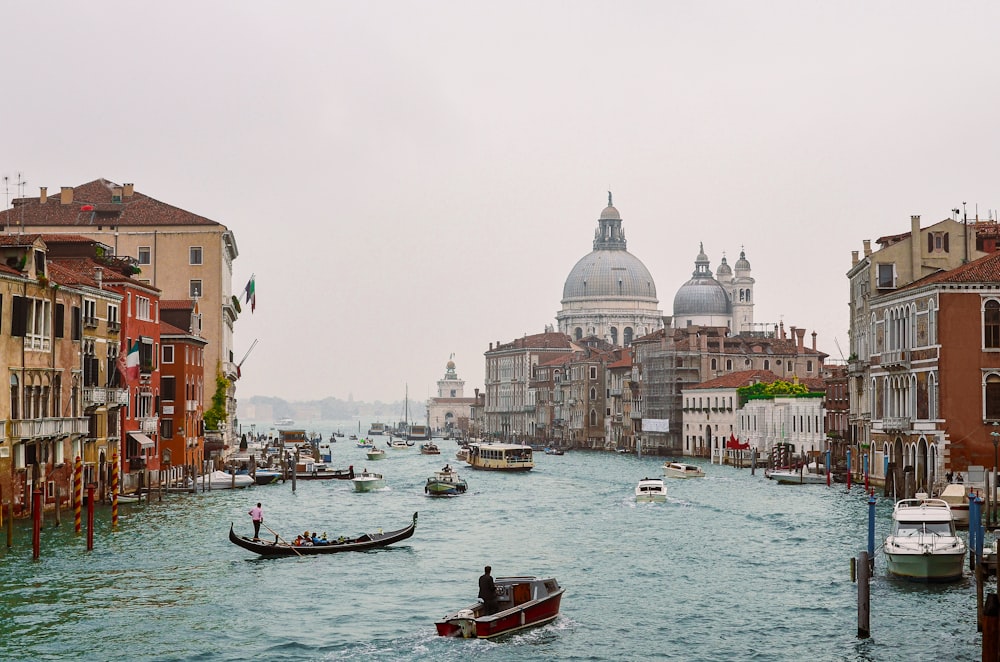 a body of water with boats in it and buildings around it with Grand Canal in the background