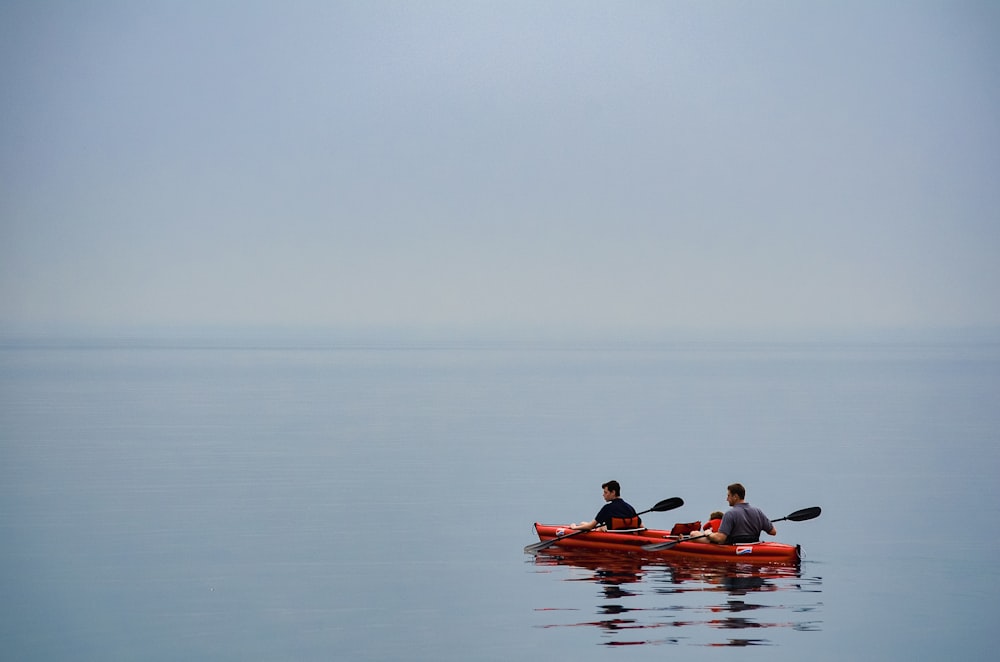 a couple of people in a canoe on a body of water