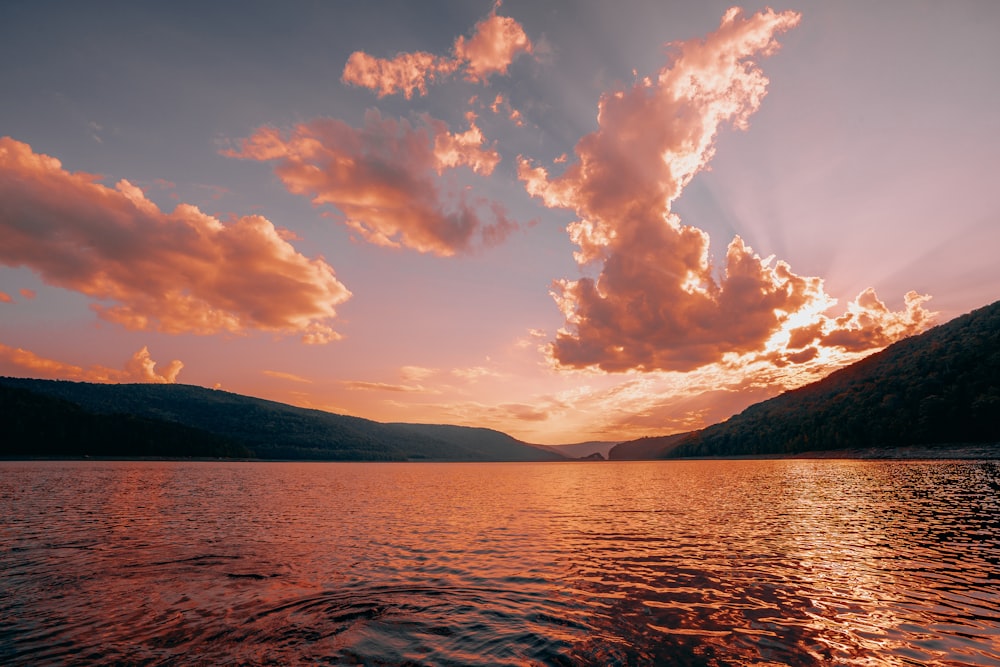 a body of water with mountains in the background