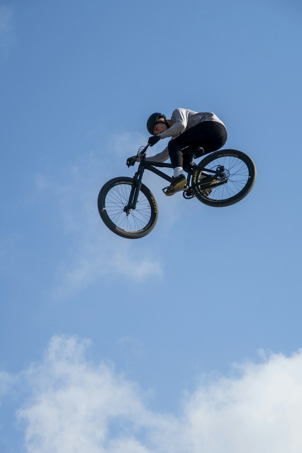 a man doing a stunt on a bicycle