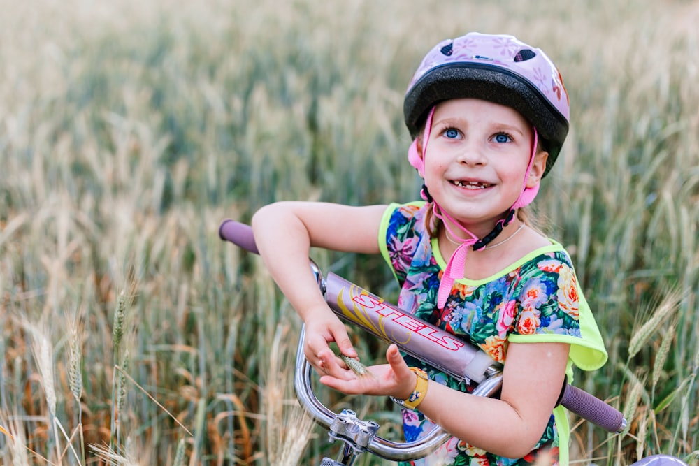 a girl holding a bicycle