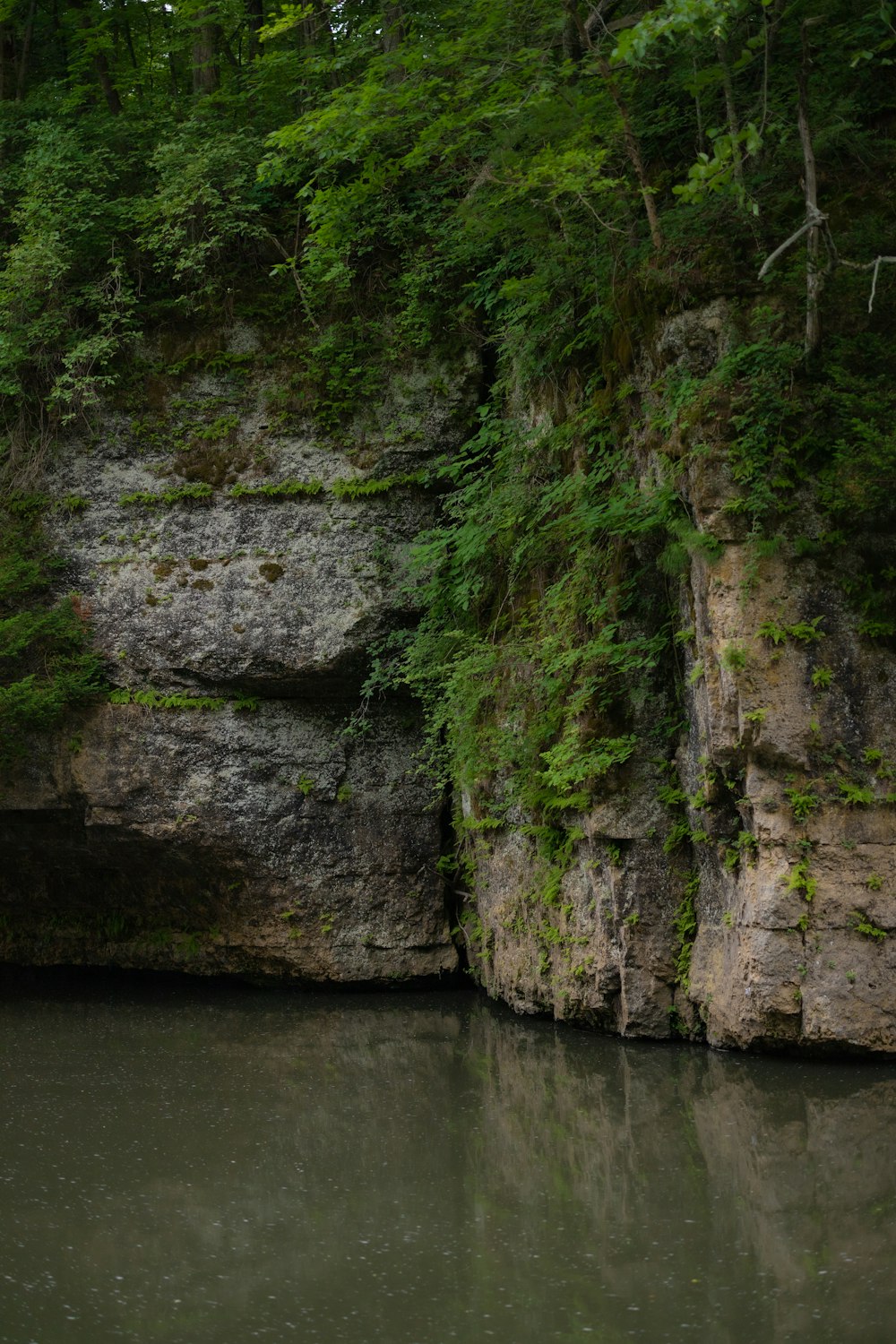 a cliff with a body of water below