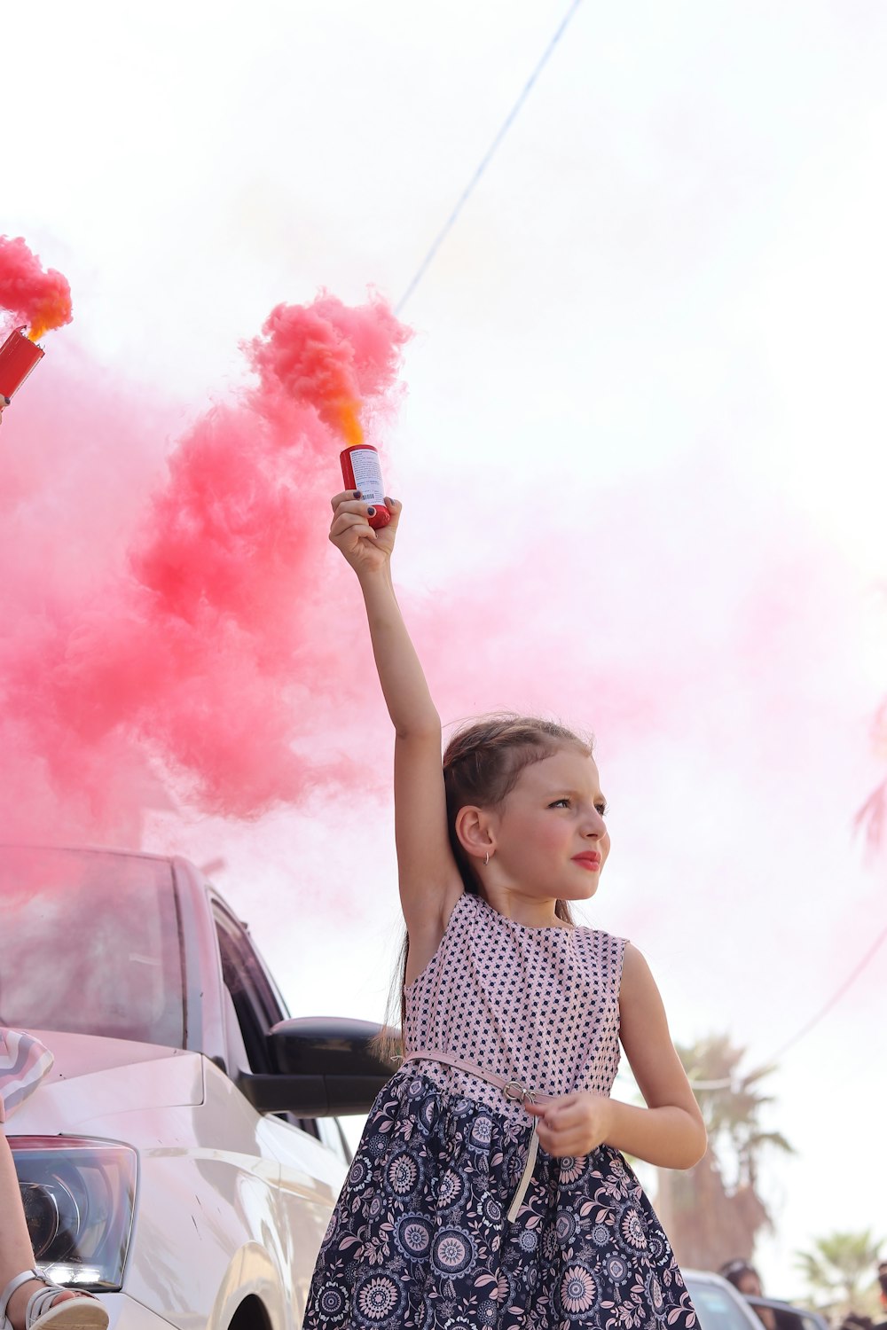 a girl holding a red and white object in the air